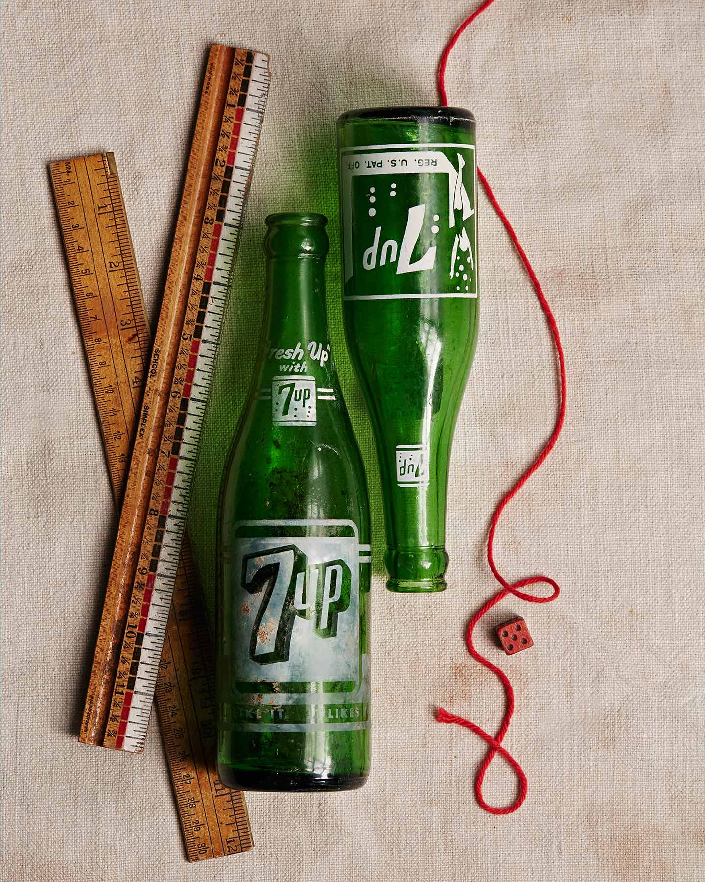 two old 7up bottles arranged in a still life photograph