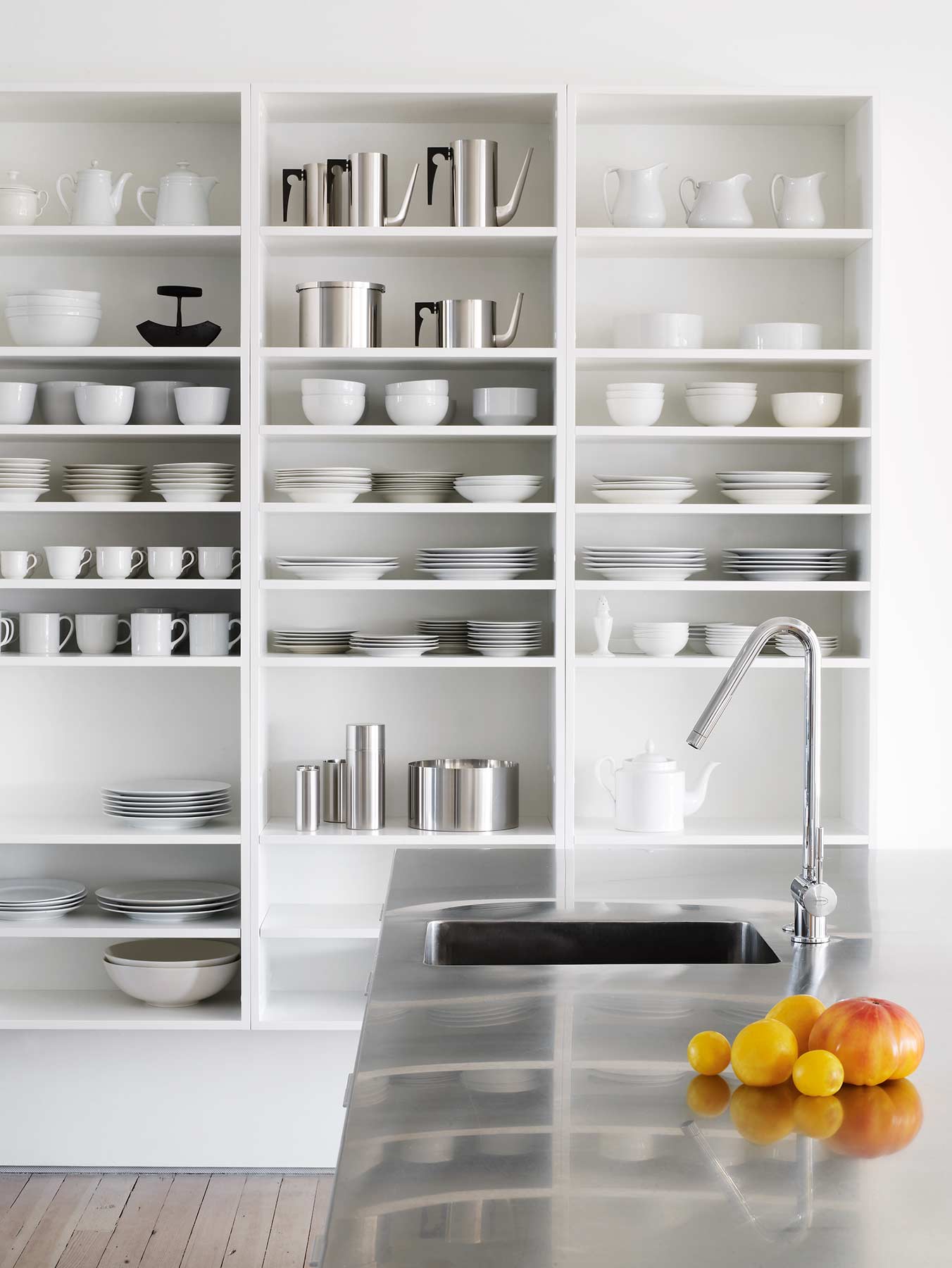 Interior of a well organized kitchen with clean white dishes