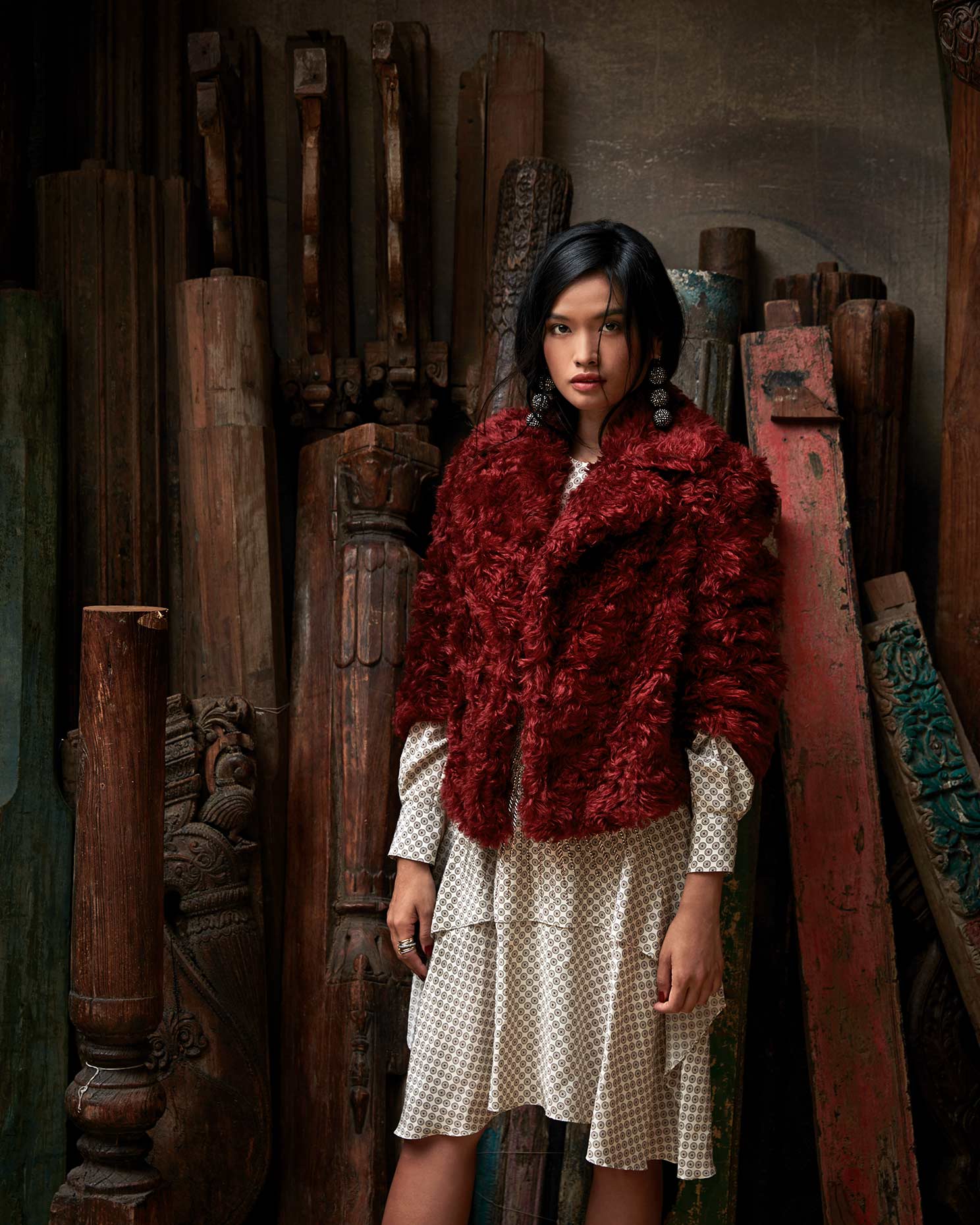Fashion photograph featuring a red furry coat on model 